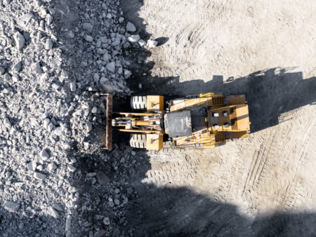 Heavy Equipment Moving Large Aggregate Material at a Quarry