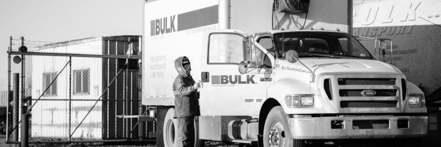 Technician Opening Bulk Transport Truck Door