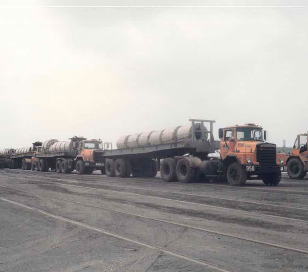 Fleet Of Trucks Hauling Coils In The Mill