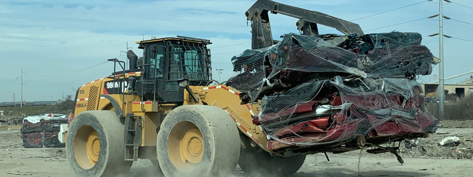 Cat® Bulldozer Hauling Car Scraps At Scrap Recyling Center