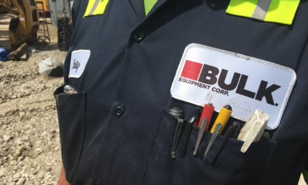 Close Up Of Bulk Equipment Corp. Logo On A Uniform