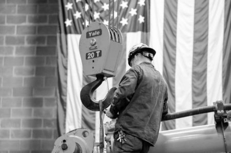 Bulk Employee At Work With Us Flag In The Background